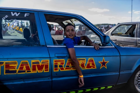 A young boy, 12, sits in his car waiting to drive at the Wheelz n Smoke Arena spinning event