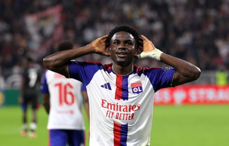 Ernest Nuamah places both hands on his head, smiling, celebrating a goal
