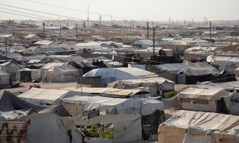 The al-Hol camp in Syria. A view of hundreds of tents under powerlines and a hazy sky
