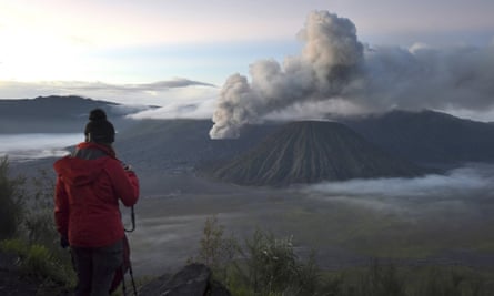 A visitor takes photographs of Mount Bromo