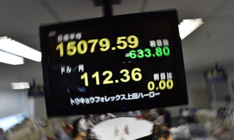 An electronic board shows a share price numbers of the Tokyo Stock Exchange. New figures show the Japanese economy shrunk at a greater rate than had been forecast.