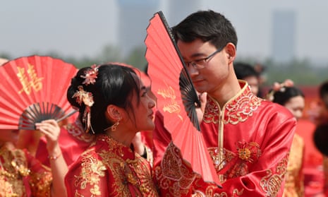  A newly wed couple in Hefei, China, on 20 May, 2023. This popular wedding date is ‘520 I Love You’ day – the pronunciation of 520 in Chinese sounds very similar to ‘I love you’. 