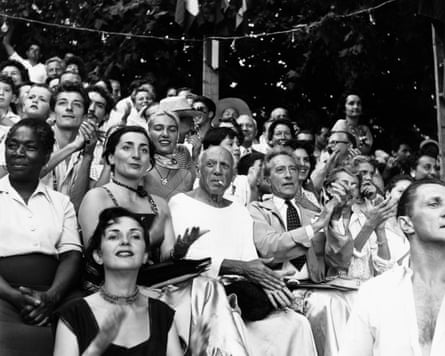 The Picasso family and friends at a bullfight in Vallauris, France, in 1955: Pablo, centre, flanked by his wife Jacqueline and Jean Cocteau and, behind them, with a scarf, his daughter Maya.