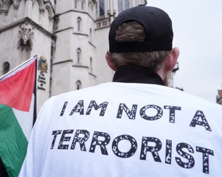 Rear view of a Palestine Action campaigner wearing a shirt with 'I am not a terrorist' on the back
