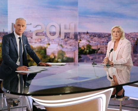 French far-right leader Marine Le Pen with French journalist Gilles Bouleau pose prior to an interview on the evening news broadcast of French TV channel TF1, in Boulogne-Billancourt, near Paris, France.