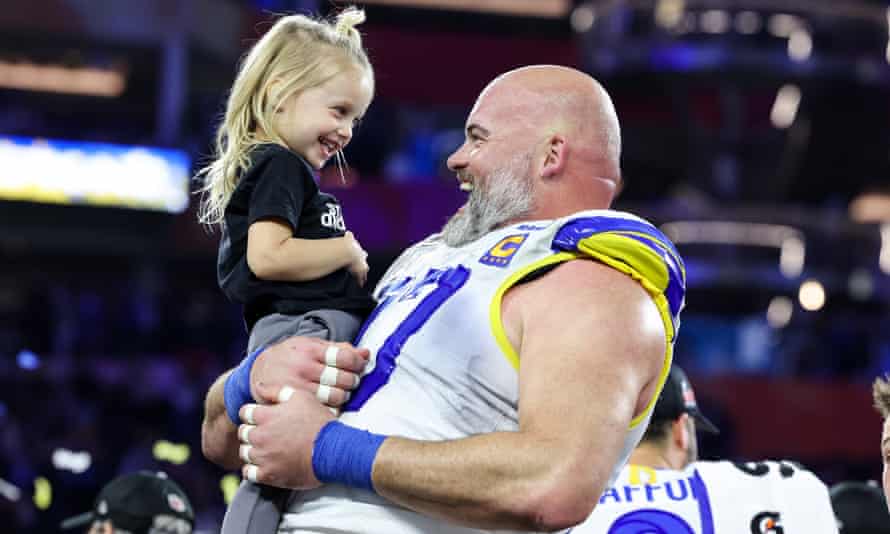 Los Angeles Rams offensive tackle Andrew Whitworth celebrates his team’s victory with Matthew Stafford’s daughter