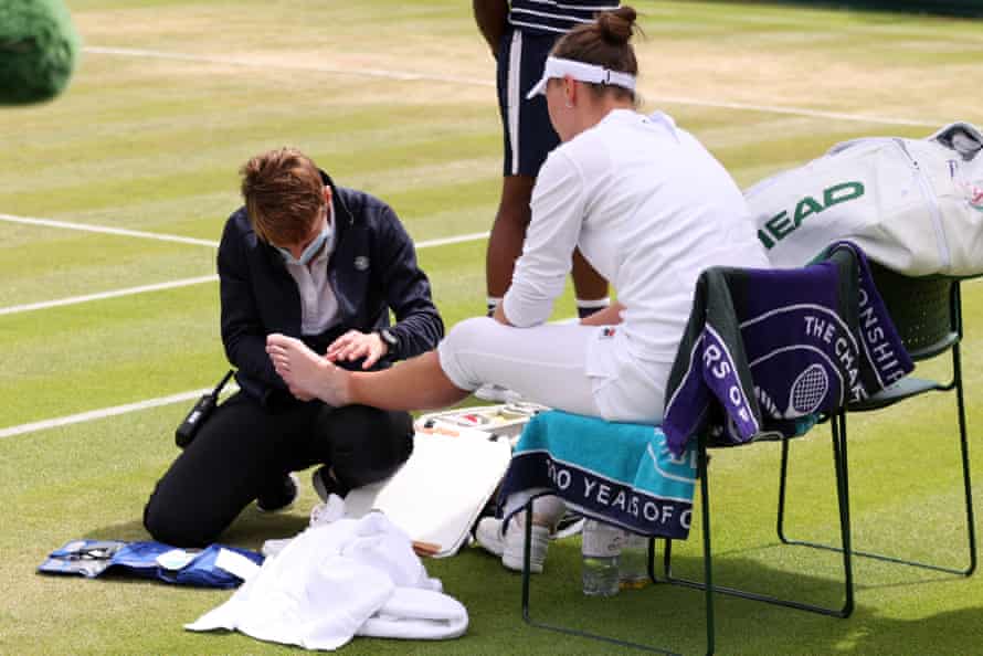 Krejcikova receives medical attention.