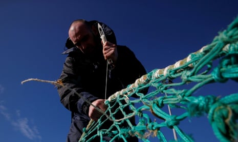 Fisherman repairs net