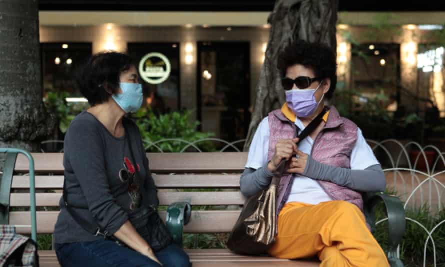 Lin, left, discusses the day’s quality with a friend.