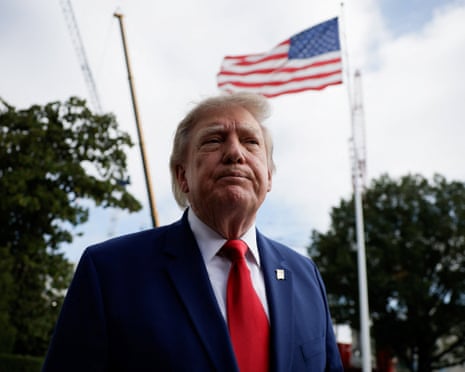 Donald Trump looks on while he speaks to reporters as he departs the White House for Joint Base Andrews en route to Dalton, Georgia.