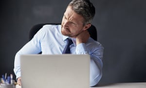 Man with neck pain sitting at laptop