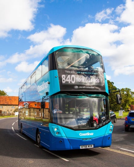 The blue and turquoise coloured 840 bus, passing through a village.