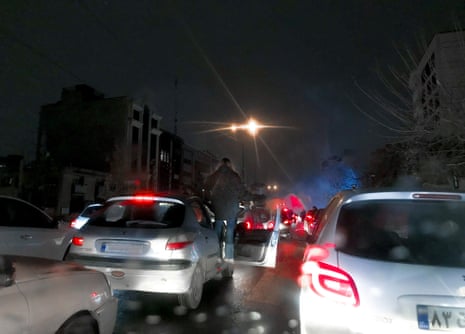 A street blocked by protesters, causing heavy traffic