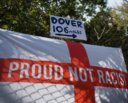 Flags and signs attached to the fence of RAF Barnham