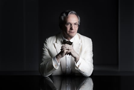 Fabio Luisi seated and wearing glasses and a white tux and black bow tie