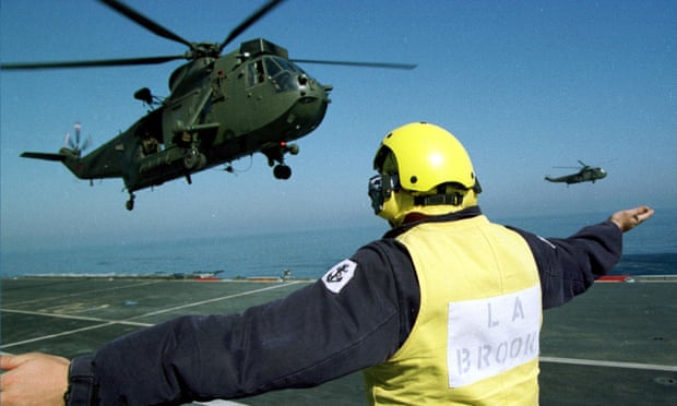 A Sea King helicopter leaves the deck of ship