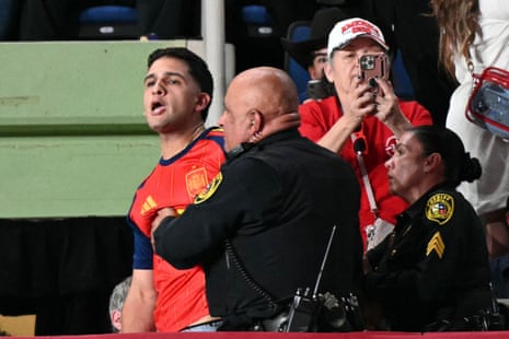 A protester wearing a soccer jersey of the Spanish national team was lead out of a campaign rally in San Antonio, Texas, on Wednesday.