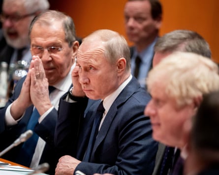 Sergei Lavrov, Vladimir Putin and Boris Johnson sit in a row at a meeting