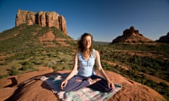 A woman meditating at a vortex site in Sedona, Arizona, US.