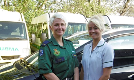 Occupational therapist with paramedic in front of ambulances