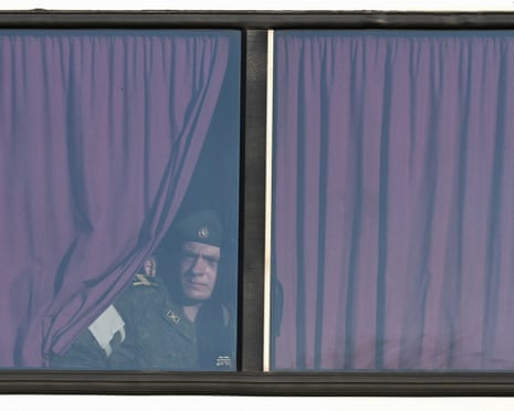 Russian serviceman looks through the window of the bus before the rehearsal of the Victory Day military parade, to be held at Red Square, in central Moscow.