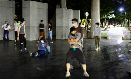 A grassroots community group train themselves in first aid and combat fitness drills at a city park in Taipei