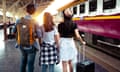 Three young people about to board a train