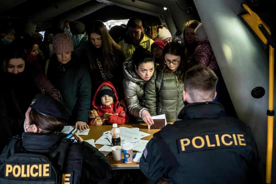 Ukrainian refugees queue to file for residency permits at Prague’s foreigner police headquarters on March 2