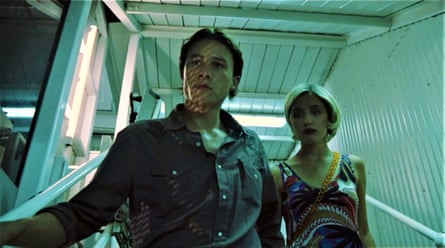 Heath Ledger and Rose Byrne exit a monorail station at night looking anxious.