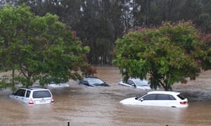 Cars sit in flood waters outside in south-east Queensland.