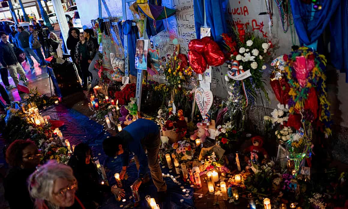 Mourners gather around a memorial for the victims of the New Year’s Day truck attack