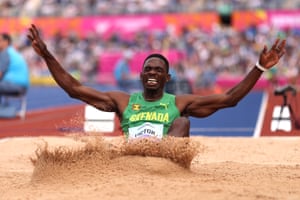 Lindon Victor of Grenada lands in the sand during the men’s decathlon long jump.