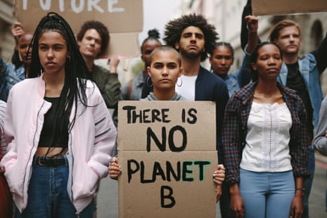 A group of activists protesting over global warming, with one woman holding a banner saying: There is No Planet B.