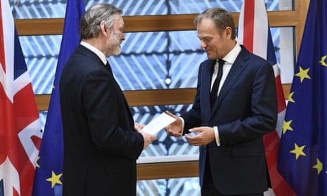 UK envoy Tim Barrow (left) hands Donald Tusk the letter giving Britain’s formal exit notice.