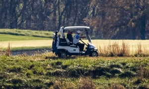 Trump waves to media across the Potomac River as he plays a round of golf at the Trump National Golf Club, on 8 November 2020 in Sterling, Virginia.