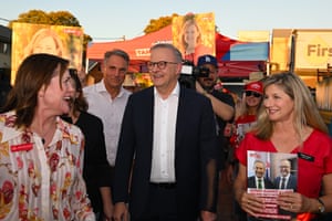Australian prime minister, Anthony Albanese, in the middle of group of people outside a polling station in the early morning in Perth, Australia.