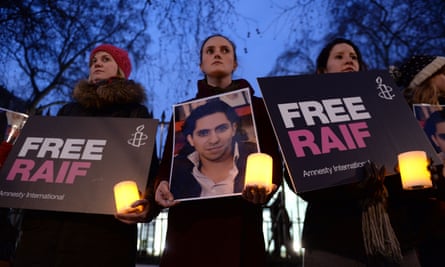 Protesters hold a vigil for the blogger and free speech activist Raif Badawi outside the Saudi Arabia embassy in London.