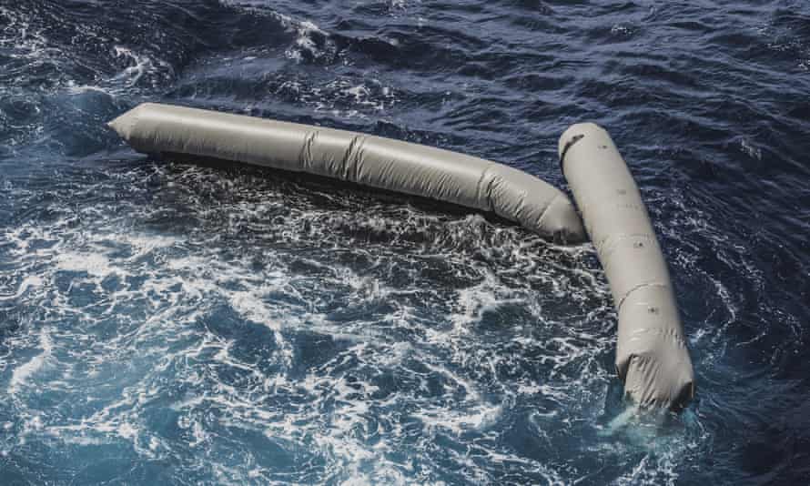 Remains of the rubber dinghy float on the surface of the ocean.