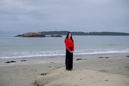 A woman stands on a beach