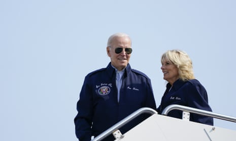 Joe Biden and the first lady, Jill Biden, stand at the top of steps of Air Force One before boarding at Andrews air force base in Maryland on Saturday as the head to the UK.