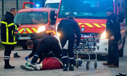 A migrant receives medical assistance following clashes in Calais.
