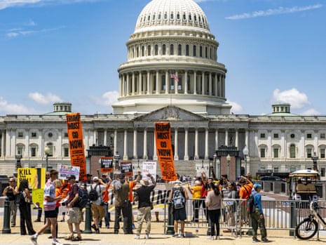 Protesters rallied near the Capitol and called for the resignation of President Trump on Wednesday as the budget bill was discussed in Congress.