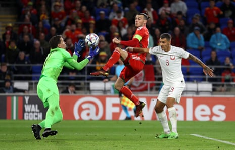 Gareth Bale of Wales collides with Wojciech Szczesny of Poland.