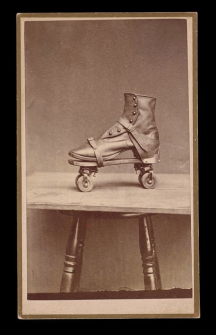 black and white photo of a boot-style roller skate on table