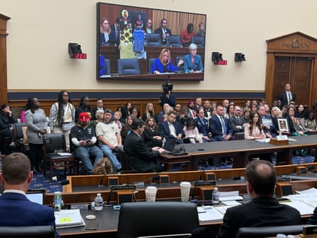 People sit for a congressional hearing