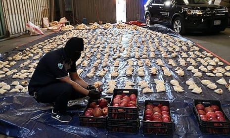 A Saudi customs officer opens imported pomegranates containing Captagon pills in Jeddah.