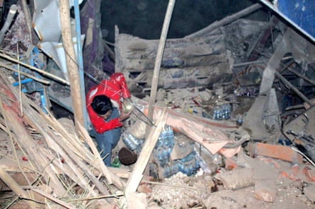 A rescuer searches through rubble after the latest earthquake in Afghanistan