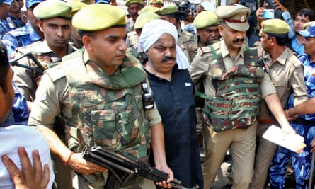 Atiq Ahmed being escorted by police officers outside a court in Prayagraj on 13 April.