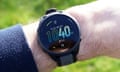 Garmin Forerunner 165 review showing the watch face on a wrist in sunlight.
