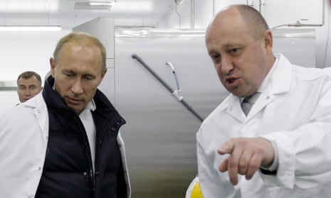 Yevgeny Prigozhin, right, shows Vladimir Putin around his school lunch factory outside St Petersburg in 2010
